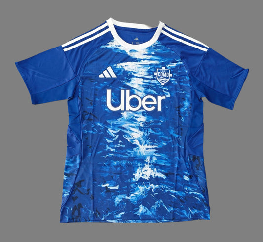 Blue sports jersey with Uber and Adidas logos on a wooden floor